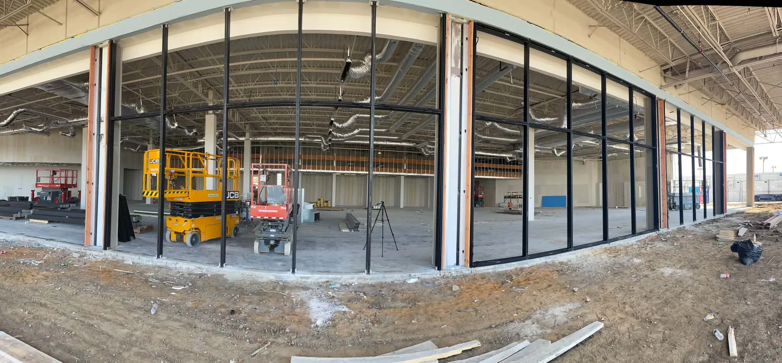 Wide view of black aluminum storefront framing and glass during construction