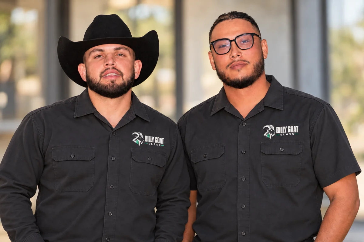 Daniel Dykeman on the left in long sleeves and a cowboy hat, with Joshua Oh on the right wearing glasses